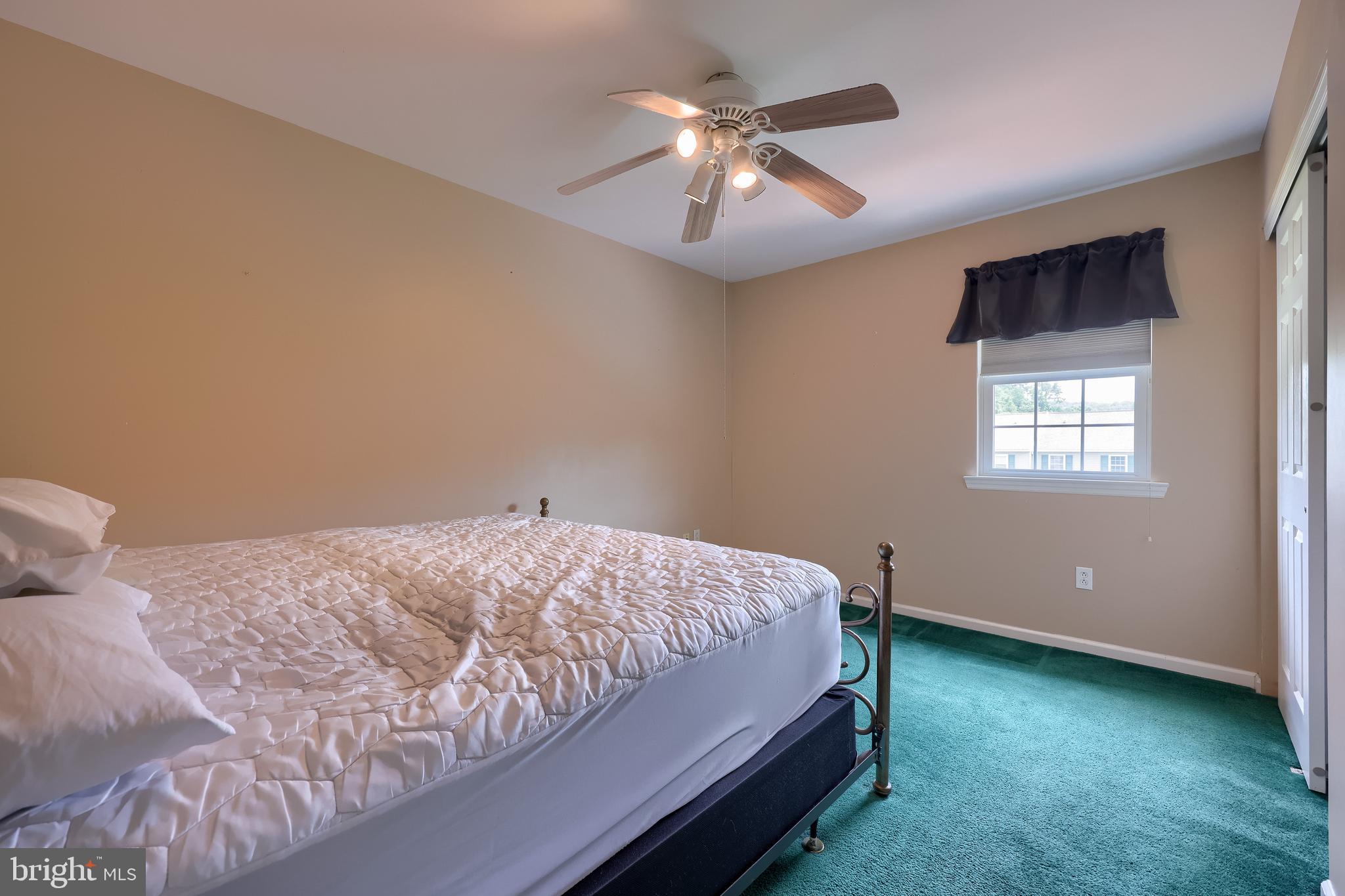 105 Bainbridge Circle Reading, PA 19608 - Photo 25 of 36 a bedroom with a bed and a chandelier