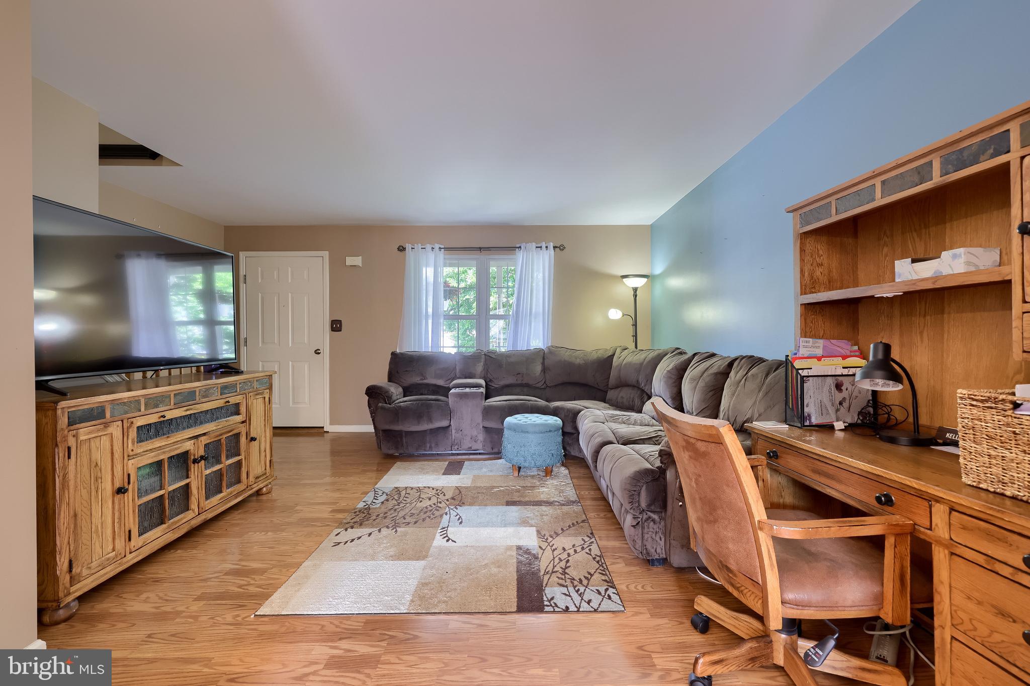 105 Bainbridge Circle Reading, PA 19608 - Photo 8 of 36 a living room with furniture a flat screen tv and kitchen view