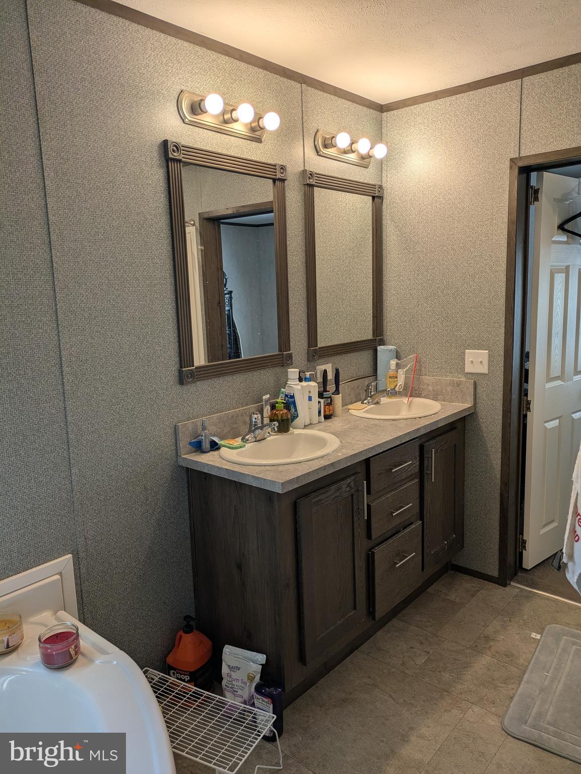 312 Berts Drive Lothian, MD 20711 - Photo 12 of 28 a bathroom with a double vanity sink and a mirror