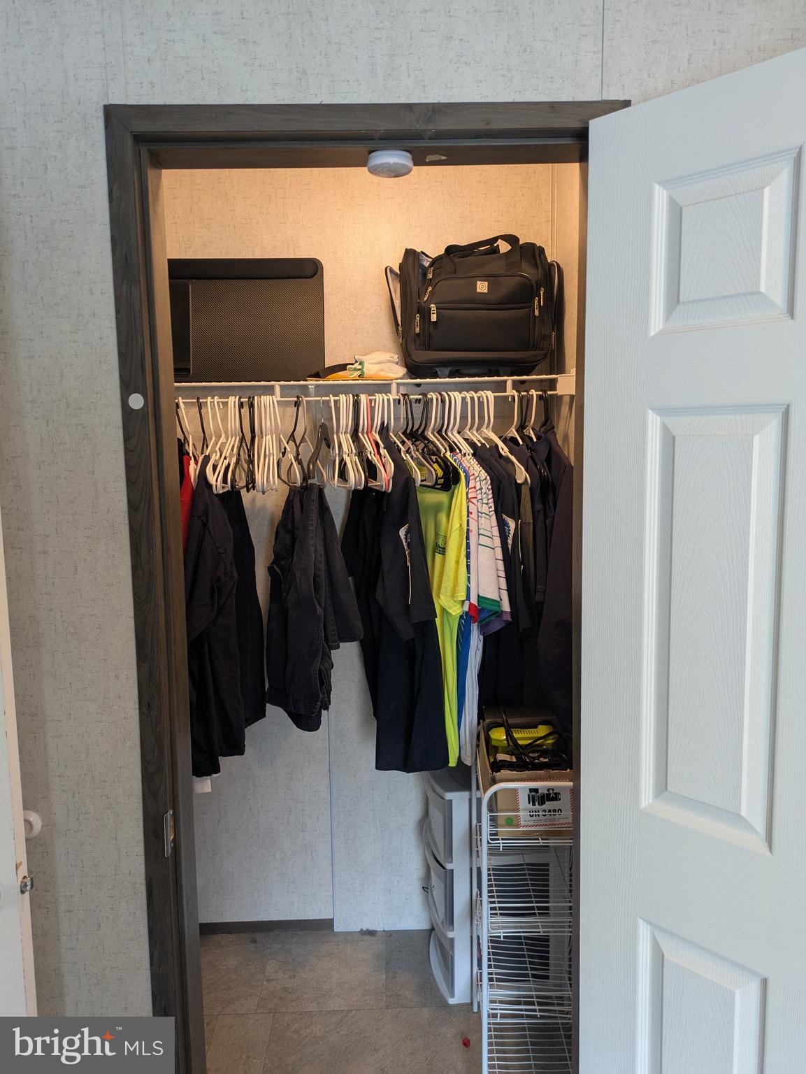 312 Berts Drive Lothian, MD 20711 - Photo 15 of 28 a view of walk in closet with clothes and shoes