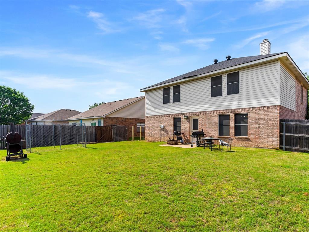 1129 Switchgrass Lane Crowley, TX 76036 - Photo 35 of 40 a view of a house with a yard and sitting area