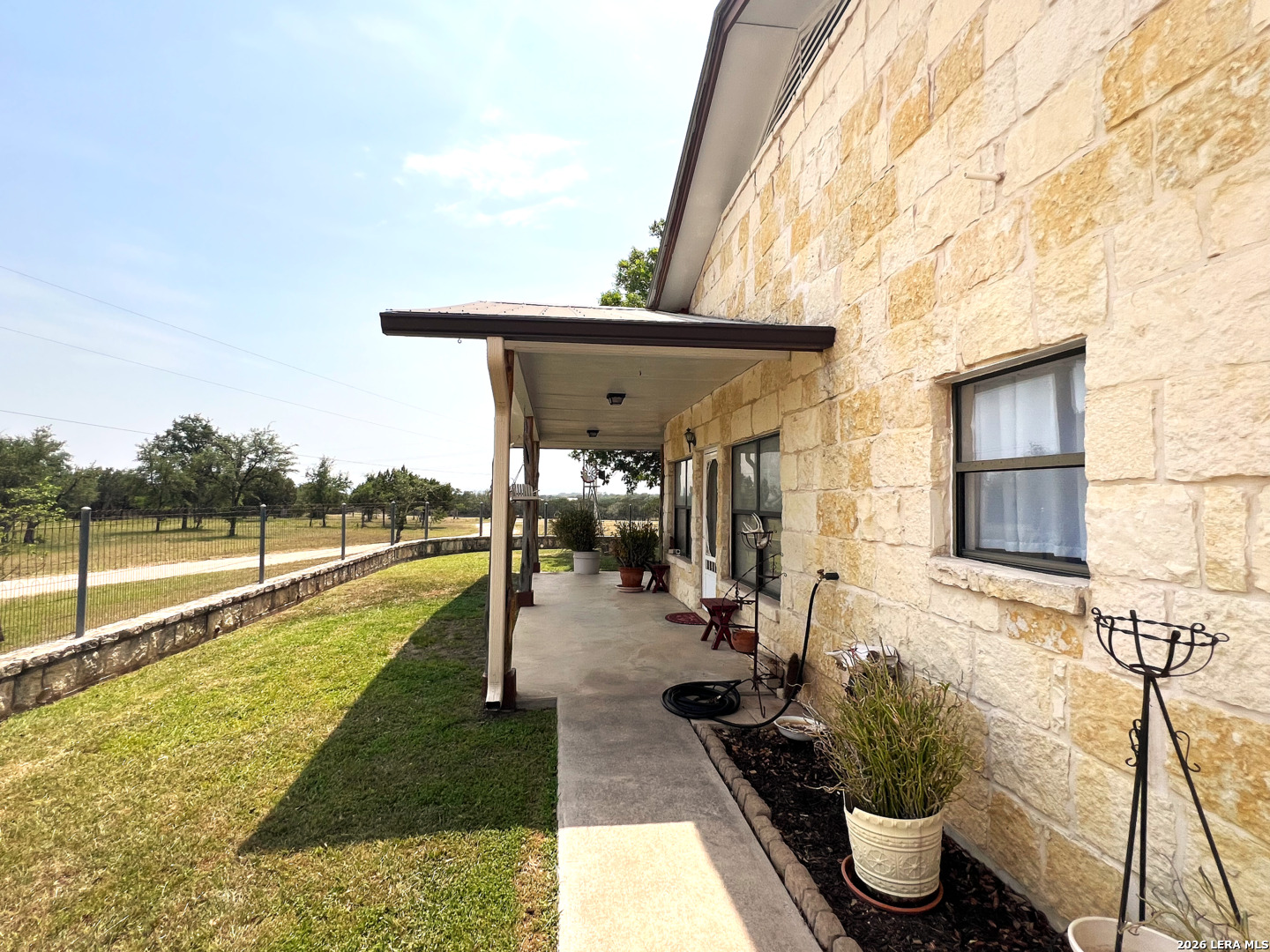 1220 Flying T Ranch Road Bandera, TX 78003 - Photo 13 of 27 a view of a balcony with chair and potted plants