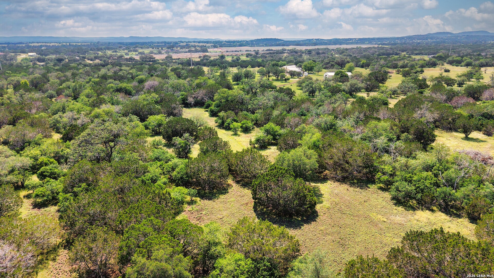1220 Flying T Ranch Road Bandera, TX 78003 - Photo 15 of 27 a view of a city with lush green forest
