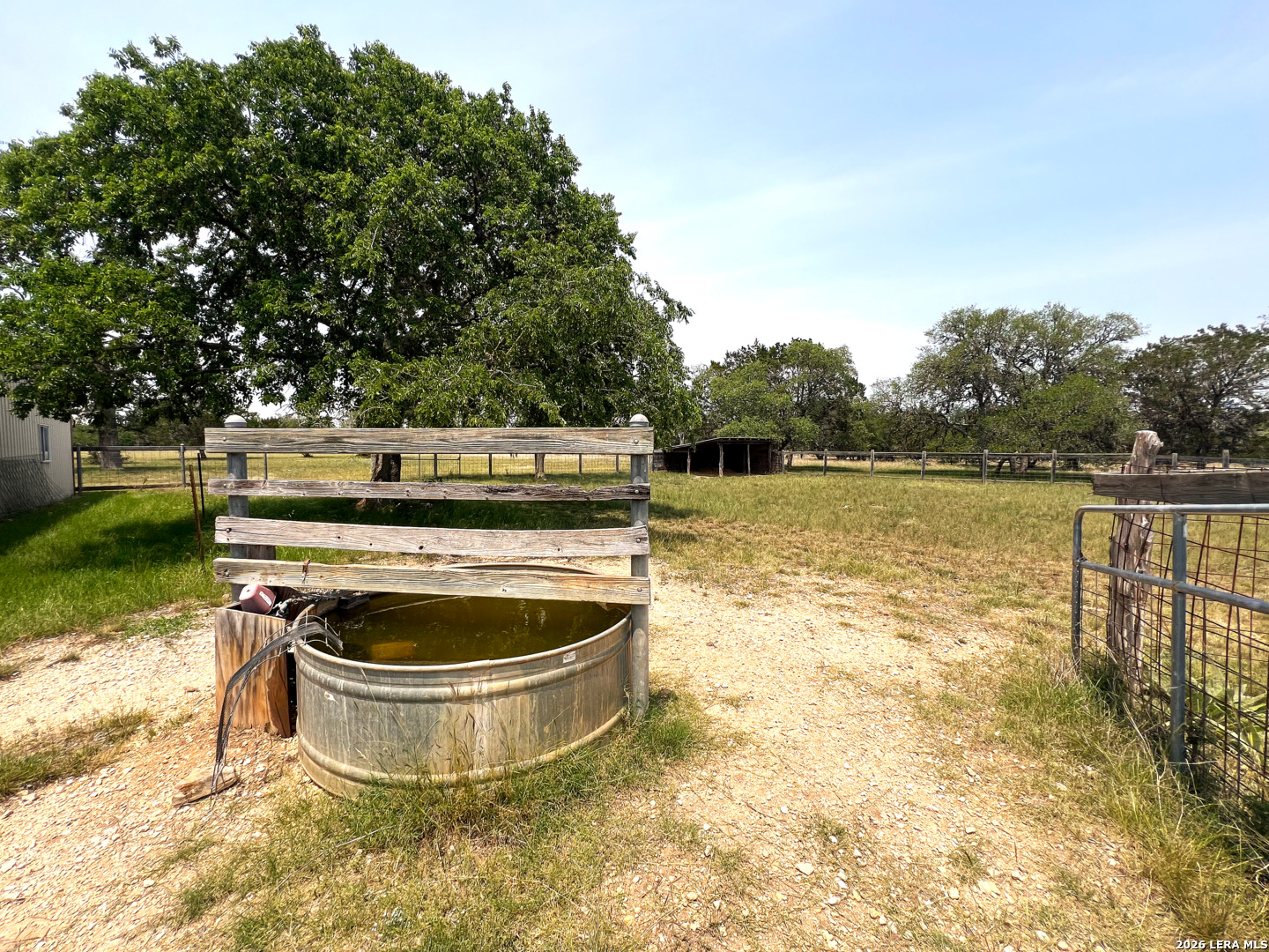 1220 Flying T Ranch Road Bandera, TX 78003 - Photo 21 of 27 a view of a swimming pool with a yard and lake view in back