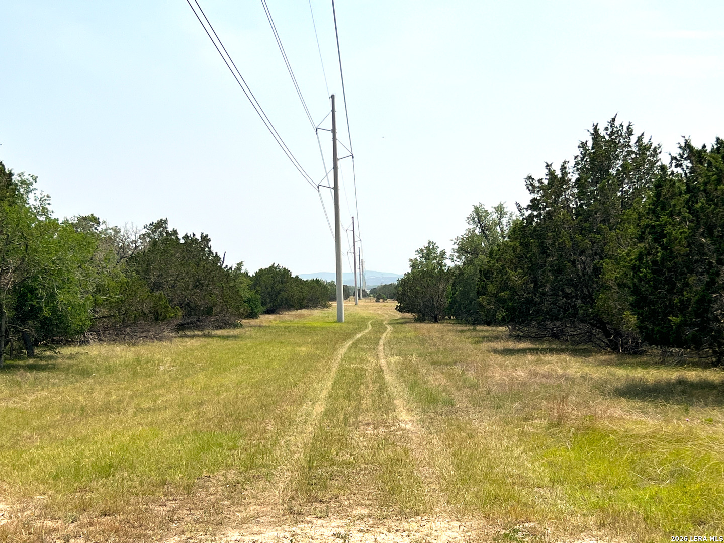 1220 Flying T Ranch Road Bandera, TX 78003 - Photo 26 of 27 a view of a swimming pool with a yard
