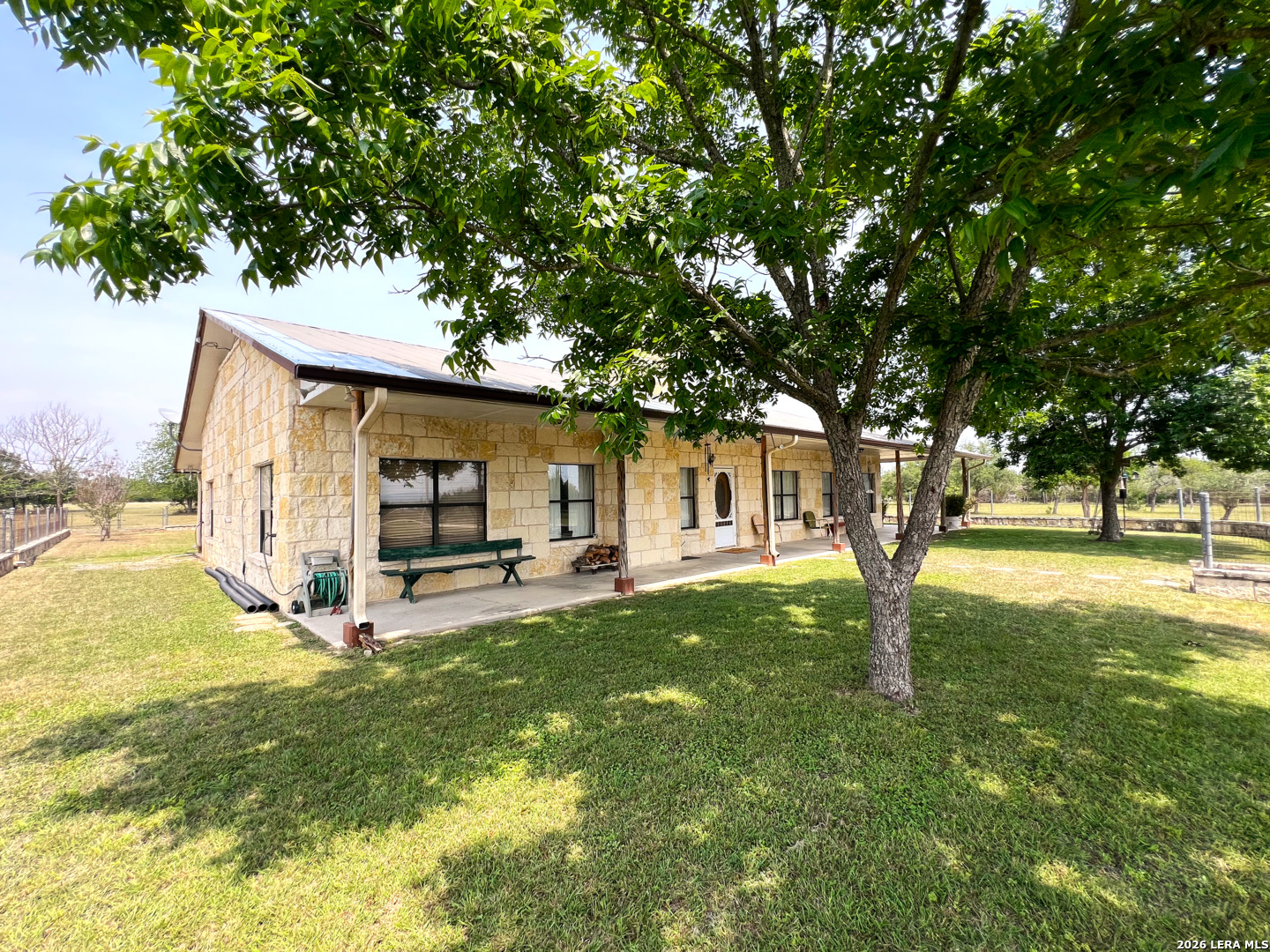 1220 Flying T Ranch Road Bandera, TX 78003 - Photo 6 of 27 a view of a house with backyard and a tree