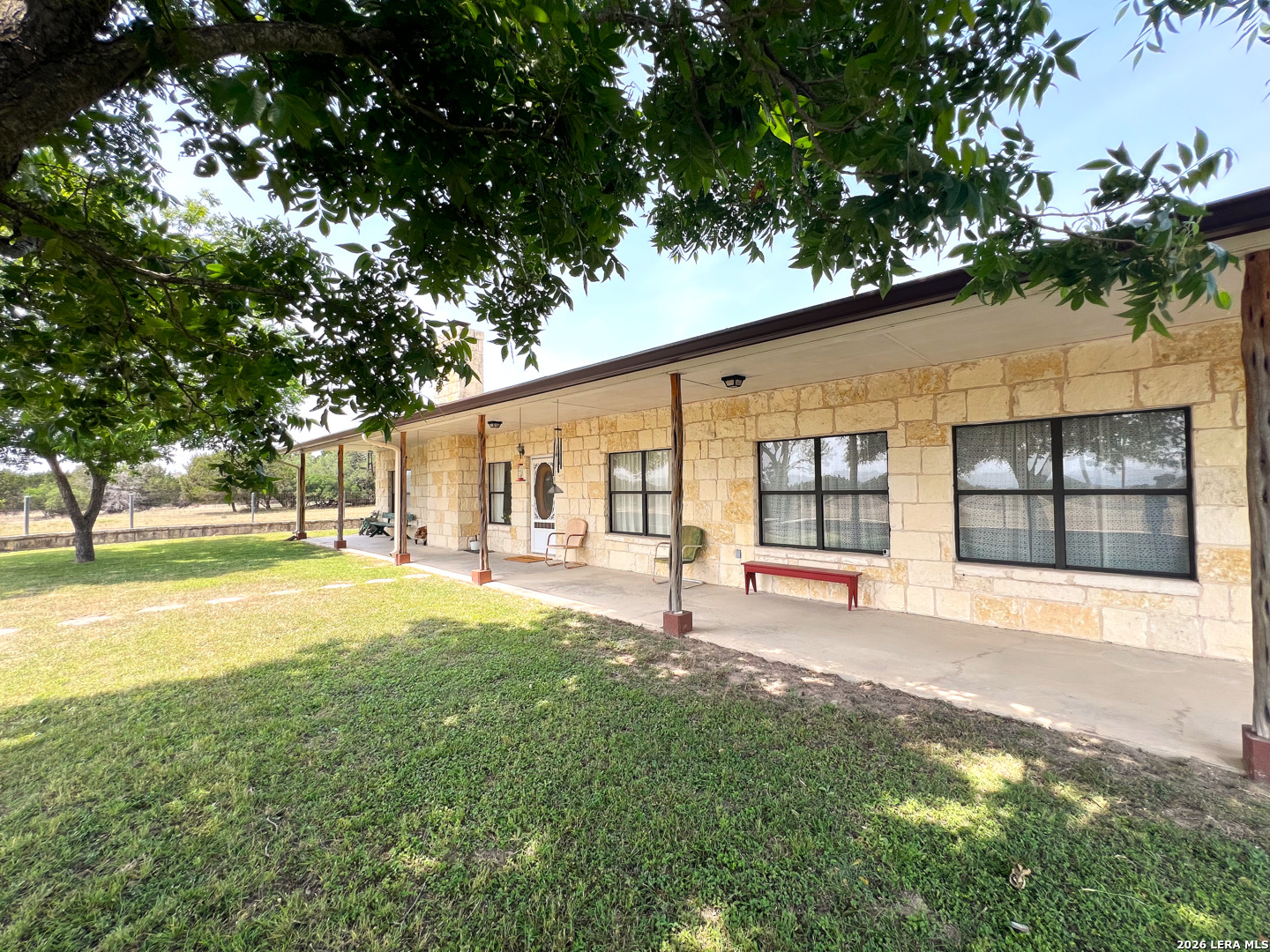 1220 Flying T Ranch Road Bandera, TX 78003 - Photo 7 of 27 a swimming pool with outdoor seating and yard