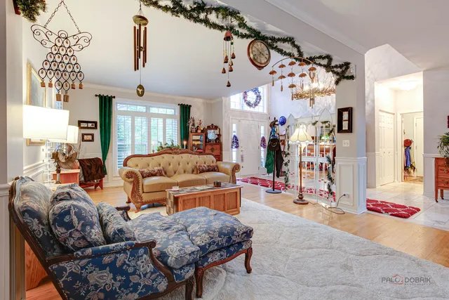 a living room with furniture and a chandelier