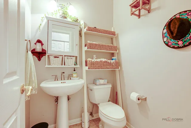 a bathroom with a toilet sink and mirror