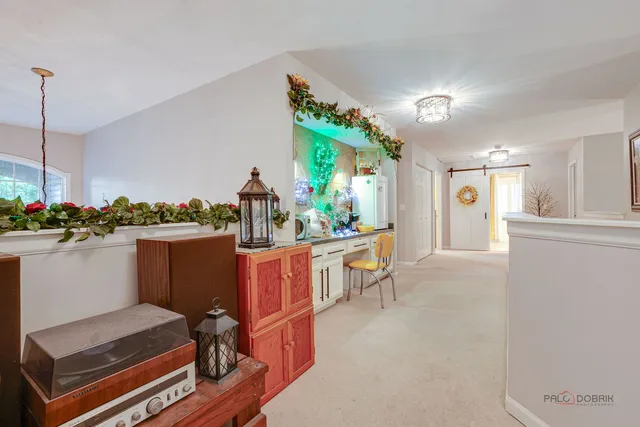 a living room with furniture and a dining table