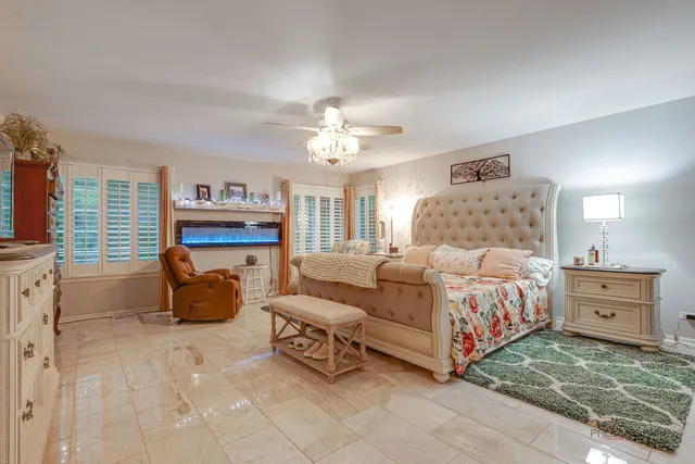 a bedroom with a bed and a chandelier
