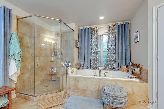 a bathroom with a tub shower and sink