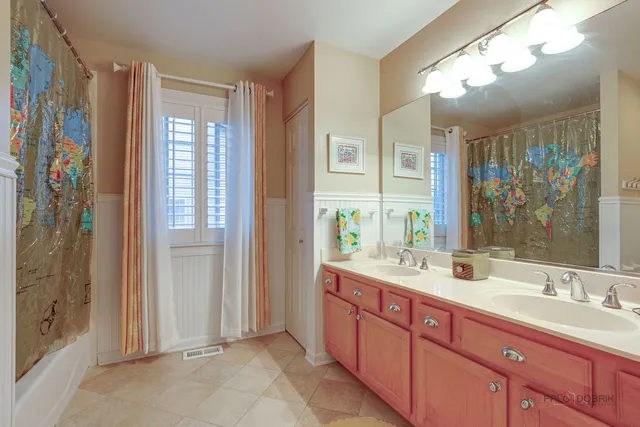 a bathroom with a double vanity sink mirror and double