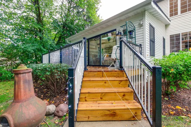 a view of a house with brick walls and a yard with plants