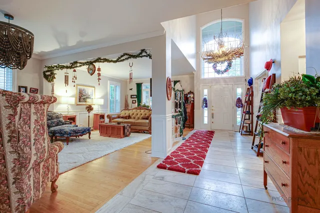a lobby room with furniture and a chandelier