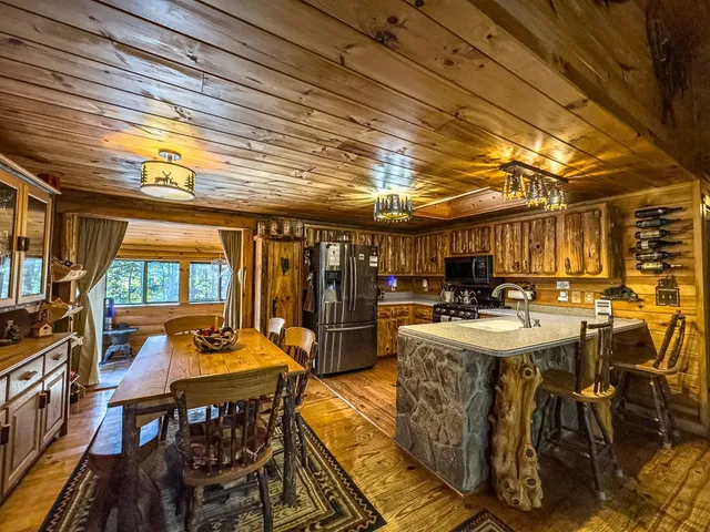 a large kitchen with lots of counter space and stainless steel appliances