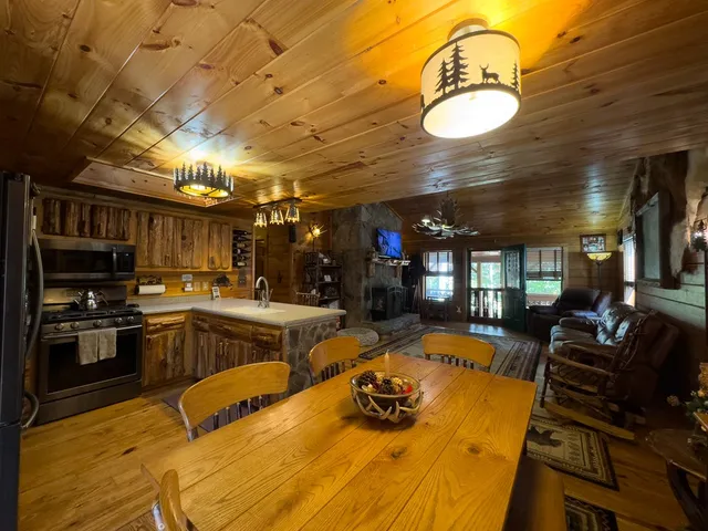 a living room with furniture a fireplace and a table