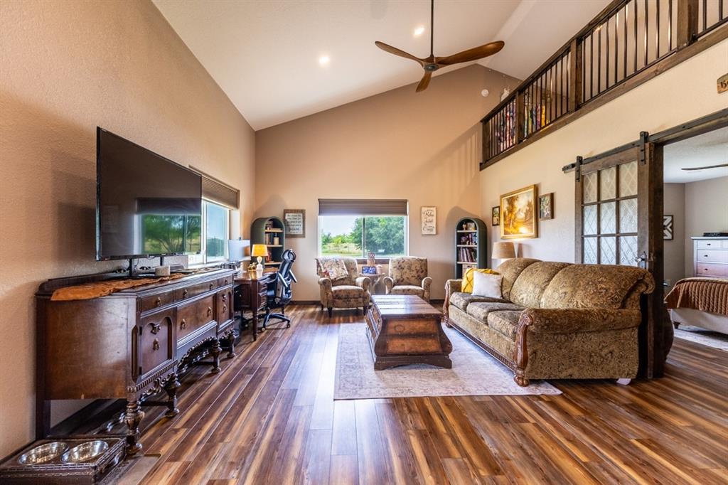 7060 Hells Gate Loop Strawn, TX 76475 - Photo 25 of 40 a living room with furniture and a flat screen tv