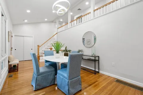 a living room with furniture a rug and wooden floor