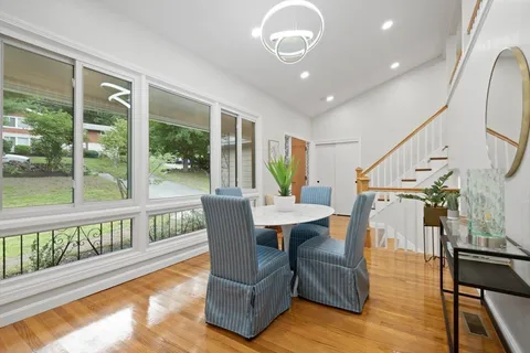 a view of a dining room with furniture window and wooden floor