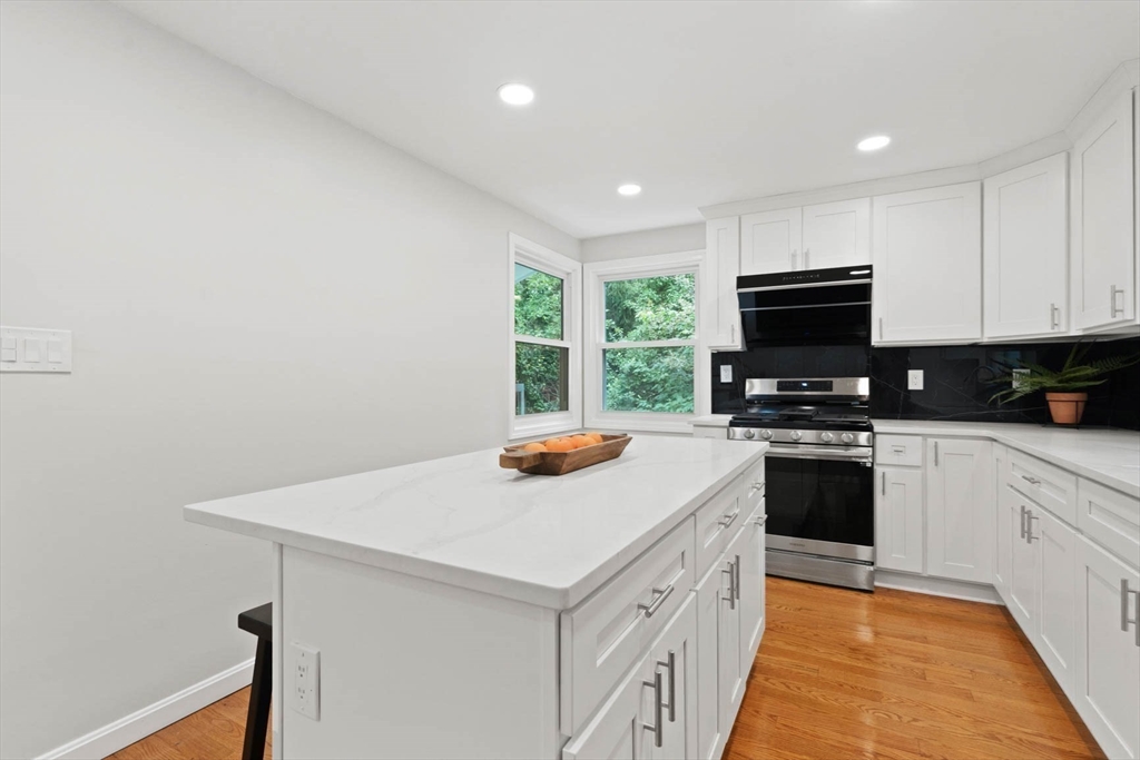 7 Thornberry Road Winchester, MA 01890 - Photo 13 of 35 a kitchen with a stove a sink and a microwave