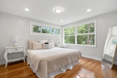 a bedroom with a bed and a large window