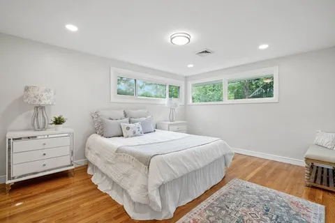 a bedroom with a bed and a painting on the wall