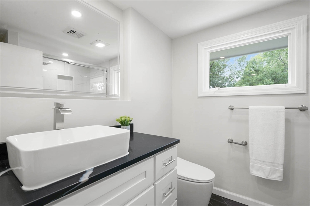7 Thornberry Road Winchester, MA 01890 - Photo 24 of 35 a bathroom with a sink a toilet and a window