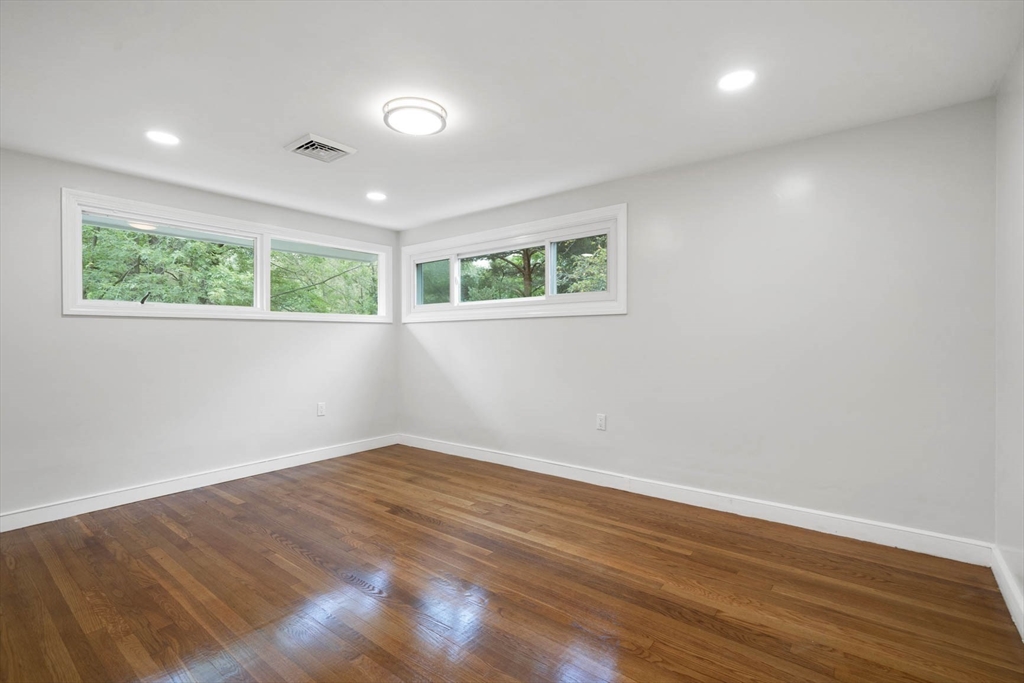 7 Thornberry Road Winchester, MA 01890 - Photo 26 of 35 an empty room with wooden floor and windows