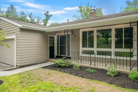 a front view of a house with a garden