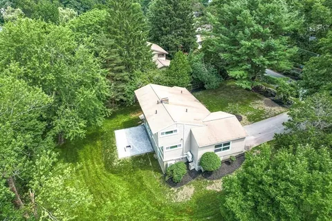 an aerial view of a house with garden space and street view