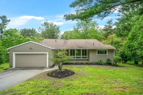 a front view of house with yard and green space