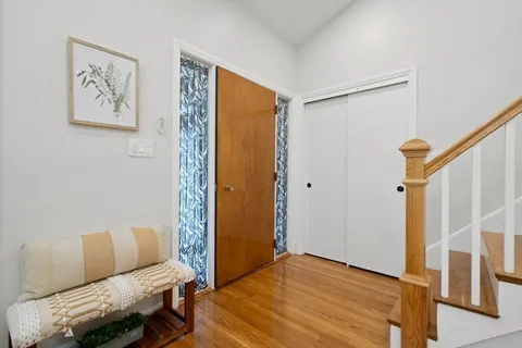 a bedroom with a bed and furniture with wooden floor