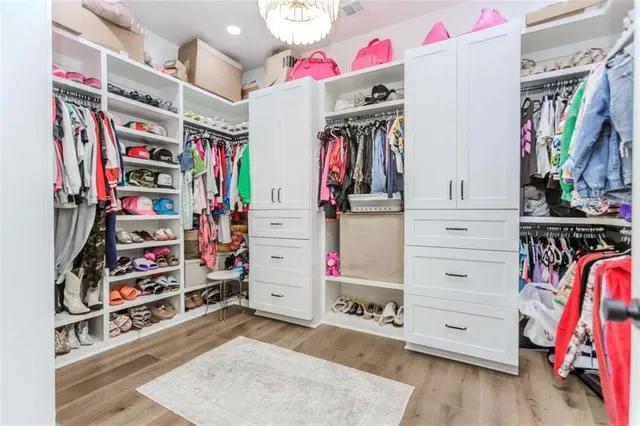 a living room with a bed and a chandelier