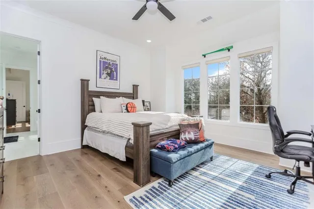 a living room with furniture a flat screen tv and a table