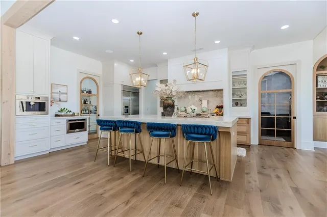 a kitchen with stainless steel appliances a sink and a refrigerator
