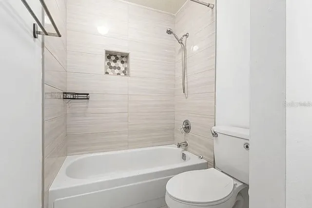 a bathroom with a toilet and a bathtub
