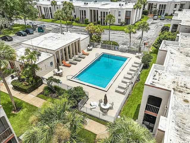 an aerial view of a house with a yard patio and outdoor seating