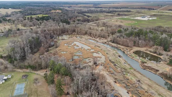 a view of a yard with wooden fence