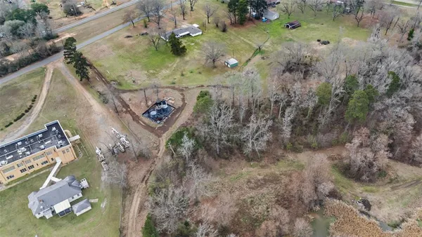 an aerial view of a house a yard and mountain view in back