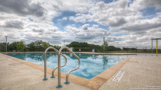 a view of swimming pool with lounge chair