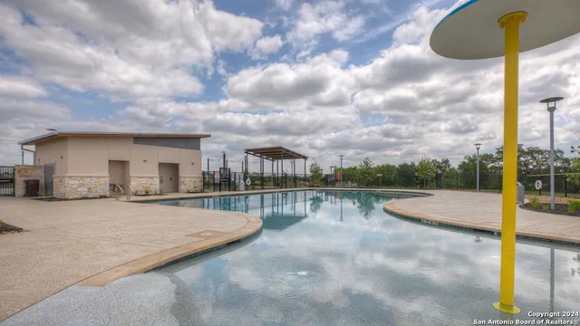a view of swimming pool with a patio