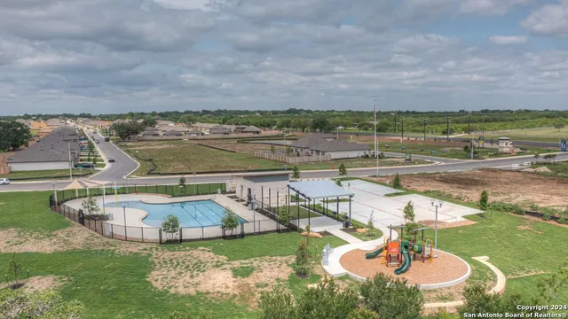 an aerial view of a house with big yard