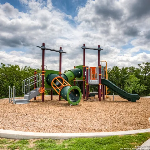 a bathroom with a sink mirror and bathtub