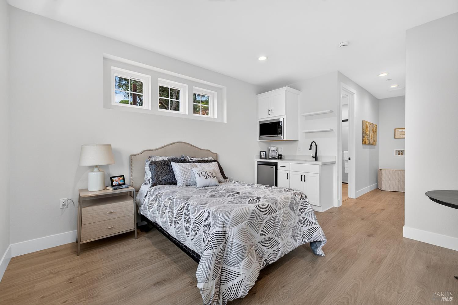 Inside the JADU you will find plenty of space for both your bedroom, dining and living area. Just past the kitchenette is the bathroom with stall shower, the hall with hookups for a stackable washer and dryer and to the right of the hall a generous walk-in closet.