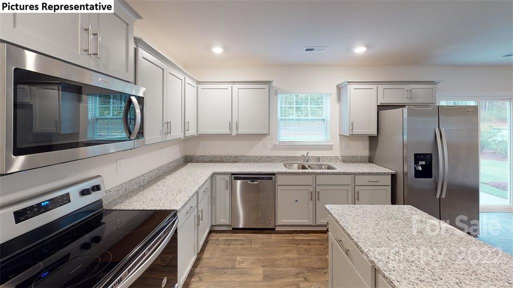 5022 Fandango Road York, SC 29745 - Photo 6 of 18 a kitchen with stainless steel appliances granite countertop a sink stove and refrigerator