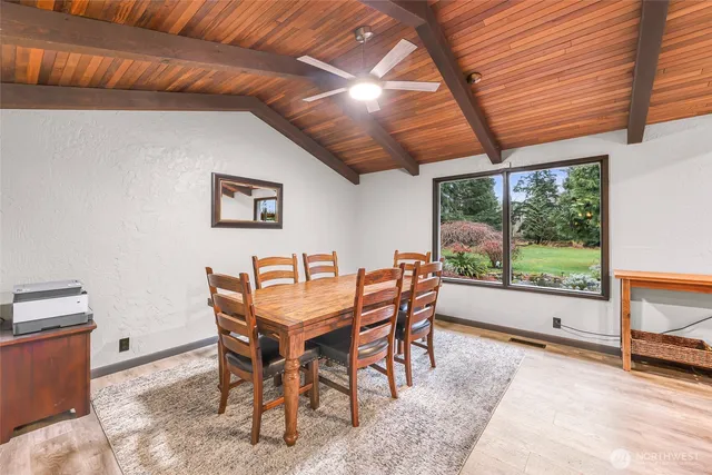 a dining room with furniture and large windows
