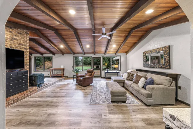 a living room with furniture a flat screen tv and a chandelier
