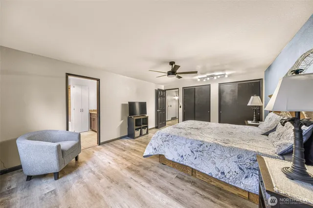 a spacious bedroom with a bed and a couch