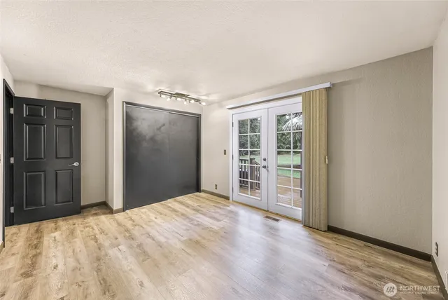 a view of a big room with closet and wooden floor